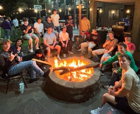 Brothers around the fire pit in the back court at night