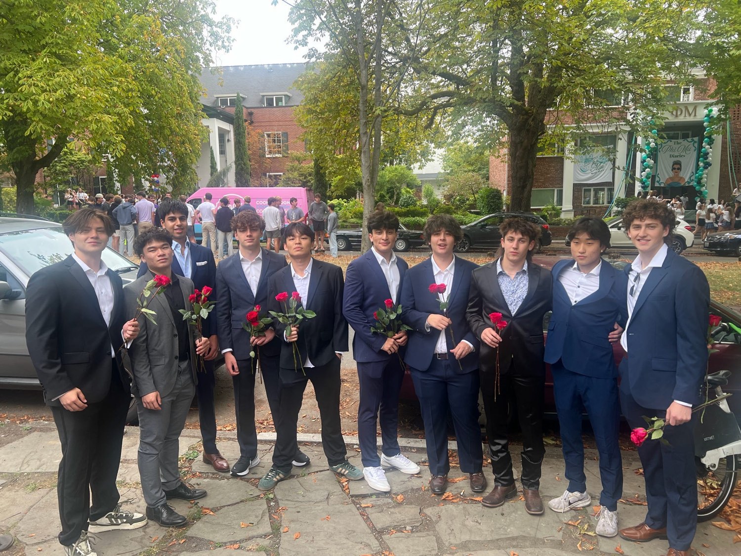 Brothers in suits holding roses