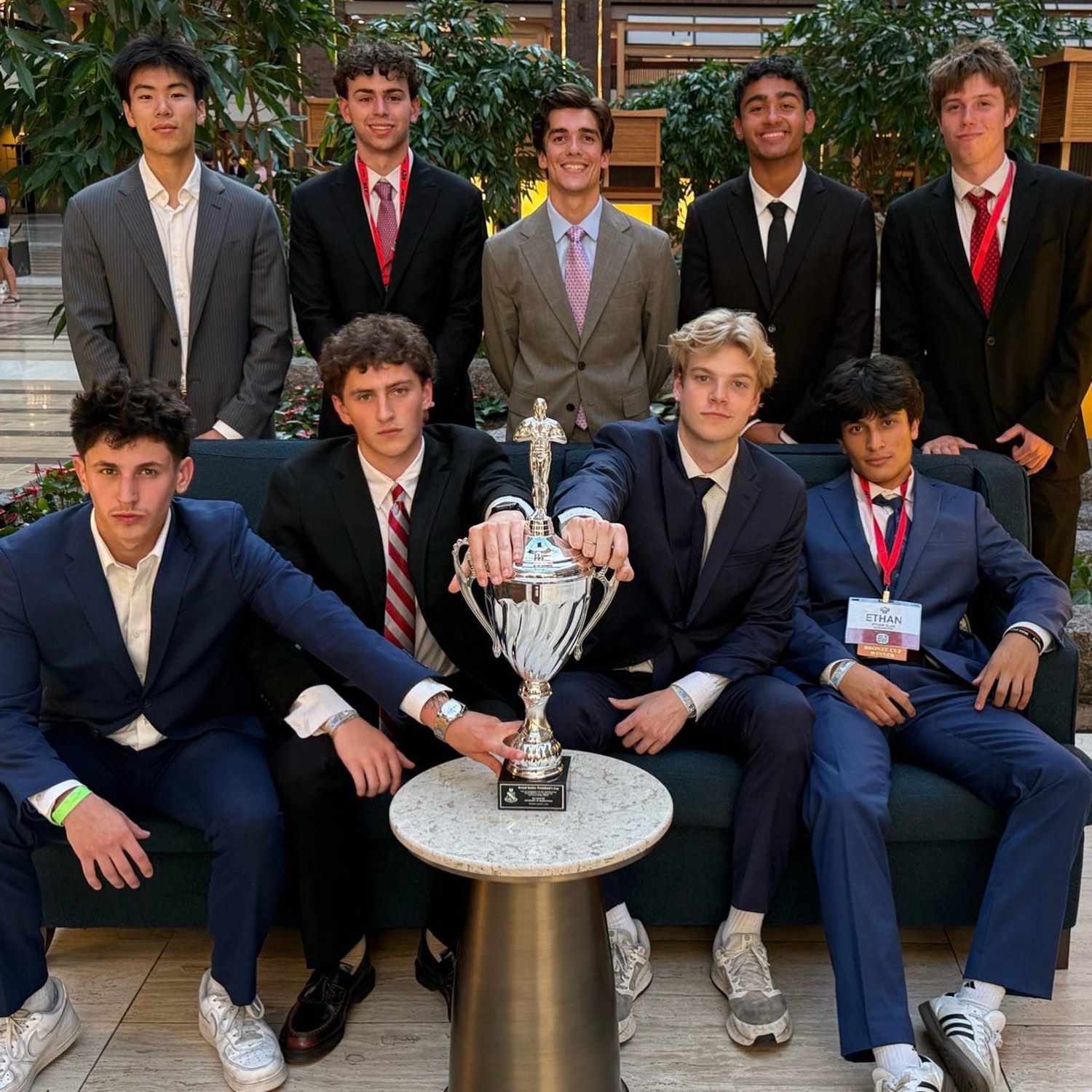 Mu Chapter brothers in suits with the Grand Senior President's Cup