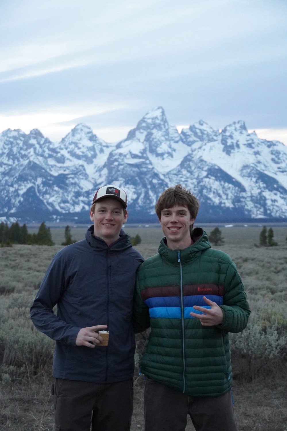 Two brothers in front of the Grand Teton range at dusk